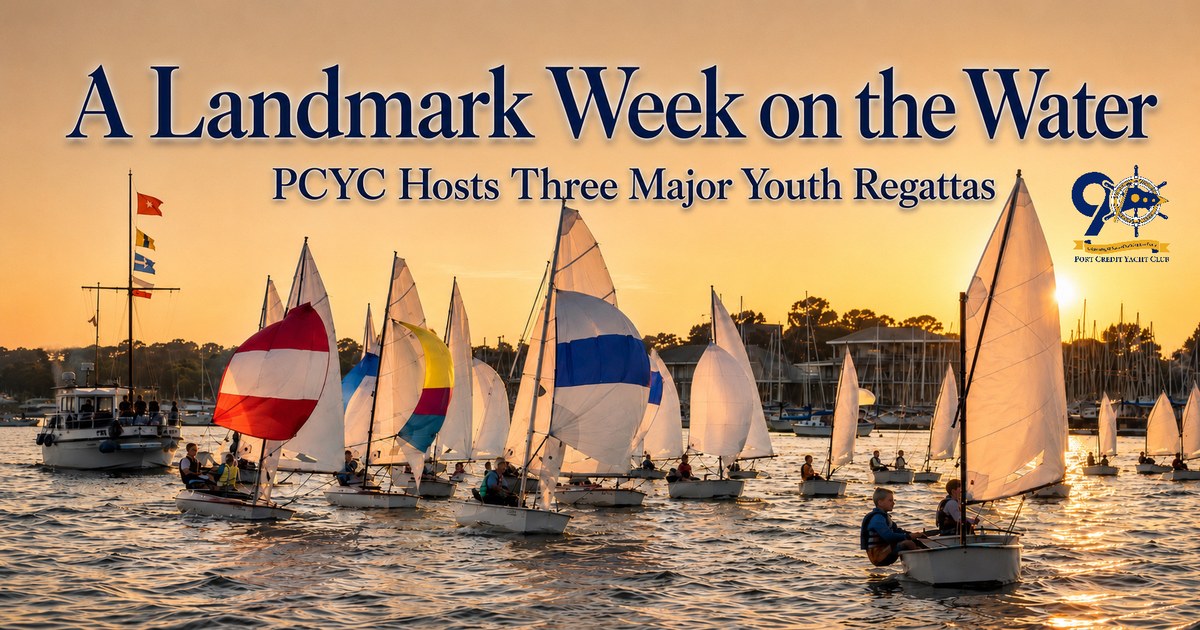 Wide photograph of dozens of youth sailing dinghies racing on Lake Ontario off Port Credit Yacht Club, marking the Club's back-to-back Steerers', Four Sisters, and Club 420 North American regattas.